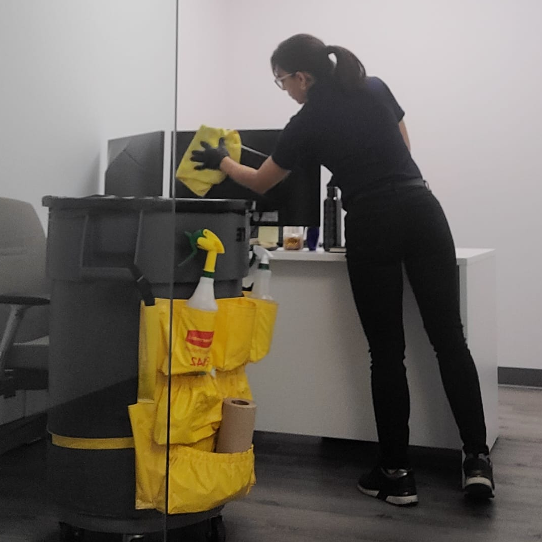 Cleaner wiping an office counter